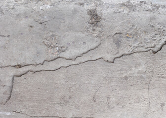 Background of destroyed concrete path, gray concrete, concrete texture, close-up. Natural photo. Old concrete slab