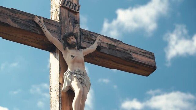 Crucifixion of Christ against the sky background. Catholicism, Christianity, faith concept. The initialism INRI Iesus Nazarenus, Rex Iudaeorum represents the Latin inscription in English translates to