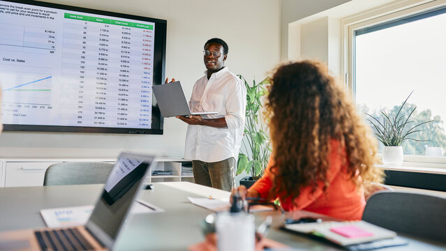 An African American Businessman Presentation on Sales Data Analysis in Modern Office