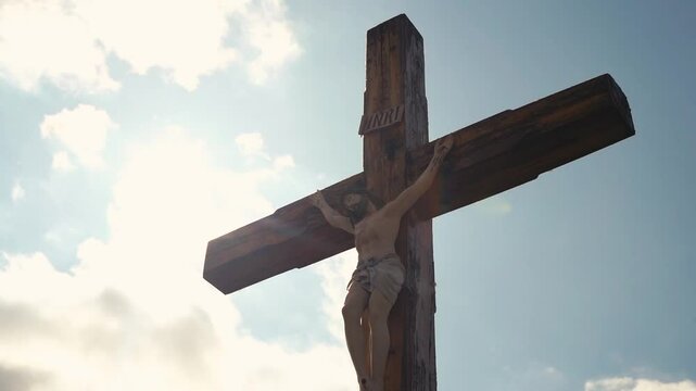 Crucifixion of Christ against the sky background. Catholicism, Christianity, faith concept. The initialism INRI Iesus Nazarenus, Rex Iudaeorum represents the Latin inscription in English translates to