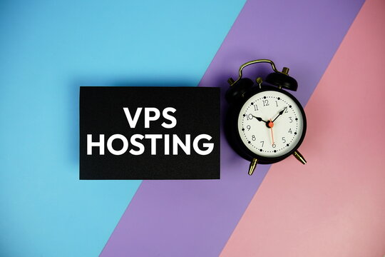 VPS Hosting text with alarm clock on paper card on blue, purple, pink geometric background