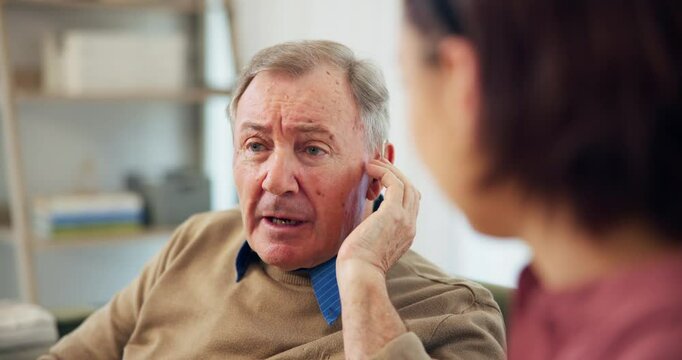 Nurse, mature man and hearing aid on ear for medical support, wellness and innovation. Person with a disability, healthcare worker and deaf patient with audiology implant, service and sound check
