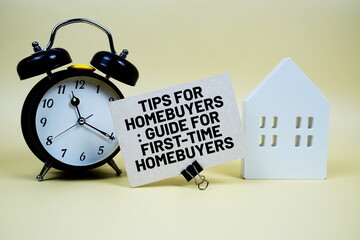 Tips For Homebuyers: Guide For First-time Homebuyers text with house model and alarm clock on yellow background