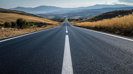 A newly paved road with crisp white lane markings under a clear sky.
