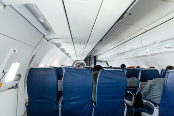 Naklejka premium Passenger plane with people in flight