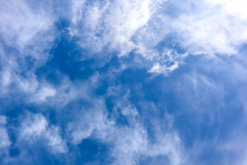 Blue sky with soft white clouds. Peaceful natural view.