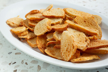 A view of a pile of bagel chips on a plate.