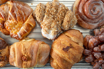A top down view of a variety of donuts and pastries.