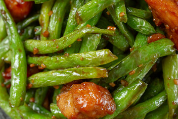A top down view of a layer of string bean chicken, as a background.