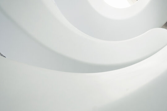 Abstract view of white spiral staircase with smooth curves and geometric patterns in The Museum of the Future, bottom view. Modern interior design in Dubai city, United Arab Emirates. View from below