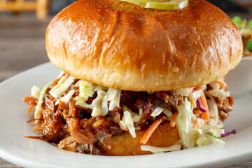 A closeup view of a pulled pork sandwich.