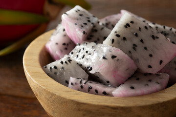 A closeup view of a bowl of chopped red dragon fruit.