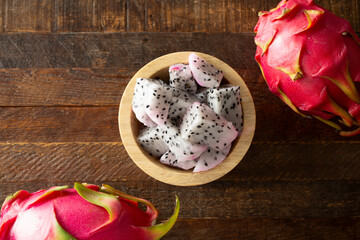 A top down view of chopped red dragon fruit in a bowl.