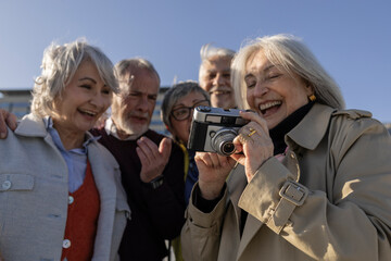 Group of friends enjoying a day outdoors, capturing memories with a camera
