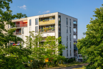 Modern apartment block with balconies and greenery in Munich, Germany