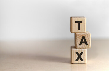 TAX text on wooden cubes on black keyboard