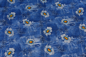 White daisy pattern on blue denim background