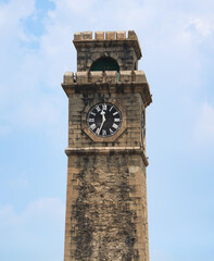A clock tower with a clock face showing the time of 10:00