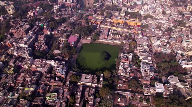 Pushkar Talab Ashram with residential buildings and trees at varanasi, kashi, banaras, uttar pradesh, india. day time, push in, drone shot, 4k.