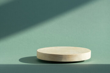 Wooden 3d podium, for presentations of packaging and cosmetics. Round platform on green background...