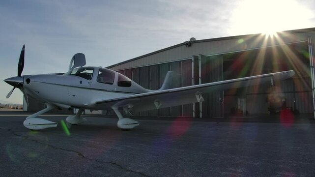 Cirrus SR22 in front of Airplane Hangar, Sunshine from Behind STATIC