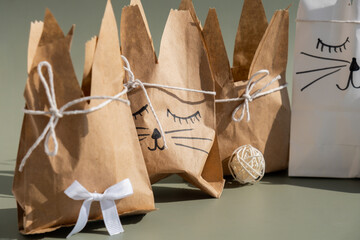 DIY candid Easter present paper bag bunny arrangement decor. Series of handmade craft paper gift...