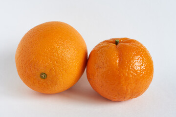 Orange and tangerine on a white background, close-up.