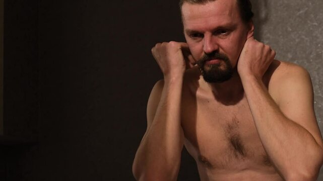 A man sitting on his bed at night experiences torment and torment expressing negative emotions upset by problems with sexual insomnia or weak erection. Preparations that improve male potency