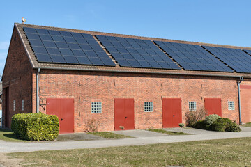 Traditional German barn with solar panels in Lower Saxony countryside © VeugerStock