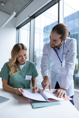 Obraz premium Doctors working on PC analyzing research data talking with colleagues