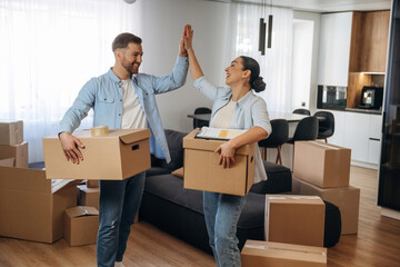 High five hands gesture. Happy couple moved into new house