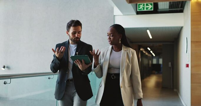 Tablet, walking and business people in office for conversation, planning or help with investment. Technology, team collaboration and discussion for financial news, economy or brainstorming solution