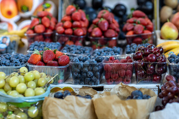 Grapes against other fruits and vegetables on the market counter