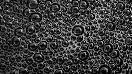 Bubbles of Reflection: An abstract, close-up shot highlighting a multitude of glistening, dark bubbles, creating a captivating visual texture and a sense of depth. 