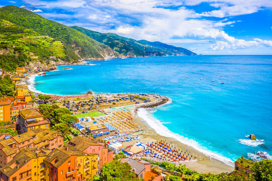 Aerial view of Monterosso al Mare in Cinque Terre, Italy, featuring its picturesque bay, vibrant traditional Italian houses, scenic coastline, and charming village atmosphere along the Ligurian Sea