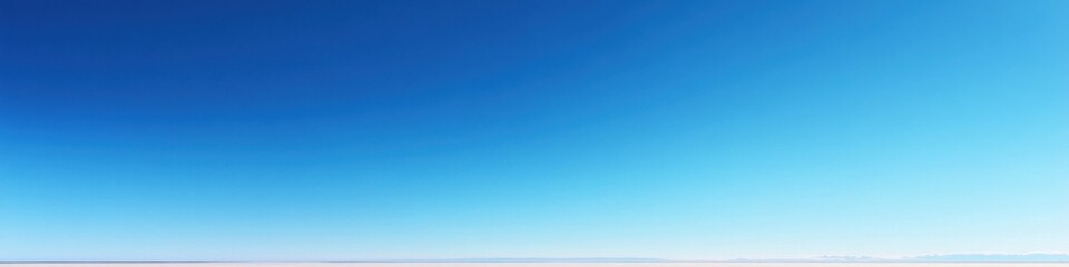 A calm lake reflecting the mountains and sky, with an empty space in the foreground perfect for text or promotional content.