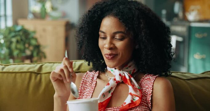 Woman, ice cream and happy on sofa with snack for satisfaction, eating and craving in house. African girl, gelato and smile in home living room on couch for frozen dessert or yogurt and sweets