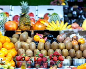 Grapes against other fruits and vegetables on the market counter
