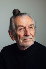 Obraz premium Portrait of a Thoughtful Senior Man with Top Knot Hairstyle