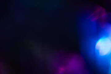 Colorful light leak on black background, abstract design with optical lens flare shot on a long lens
