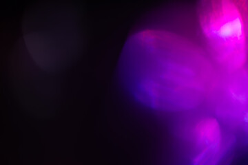 Colorful glow Light flare sparks texture. red orange rays on dark blue abstract overlay