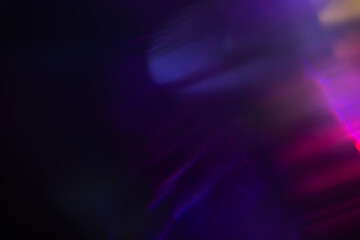 Abstract blurred colorful lens flare bokeh on black,