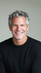 Obraz premium Portrait of a Smiling Mature Man with Graying Curly Hair