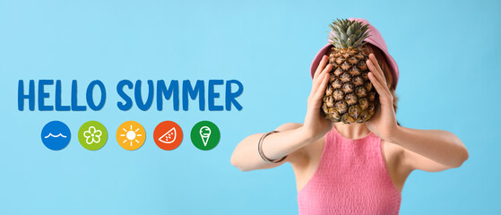 Beautiful young woman with pineapple on blue background