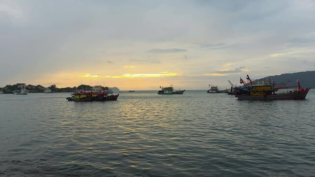 Commercial Fishing Trawlers Anchored In The Sea At Sunset Seen From Oceanus Waterfront, Kota Kinabalu, Sabah, Malaysia. - wide shot