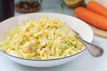 A bowl with coleslow salad	