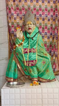 a statue of Sai Baba, reminiscent of traditional religious art, adorn in a Hindu Temple