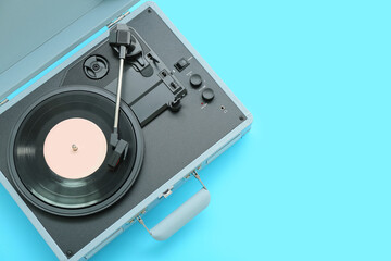 Fototapeta premium Record player with vinyl disk on blue background