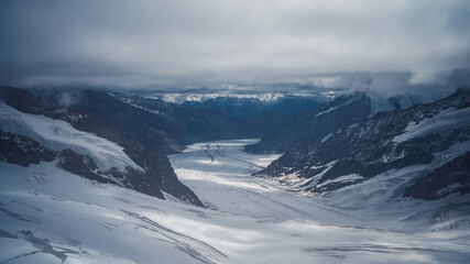 Panoramic view of a Swiss glacier (Gorner Glacier), between snow-capped mountains, in the Zermatt-Matterhorn area.