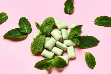 Fresh chewing gums with mint on pink background